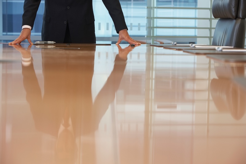 Adswerve, Apollo.io New CEOs Midsection Of Businessman With Hands On Conference Table